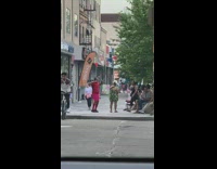 Guy wearing headphones dances on sidewalk alone 