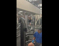 Guy with dwarfism at the gym, uses lat pulldown machine and flies up