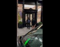 Man with pants down pushes other man on sidewalk