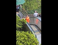Collab IITW - Woman orange dress repeats video at escalator