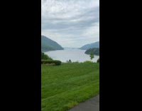 Guy sitting on bench looking at water