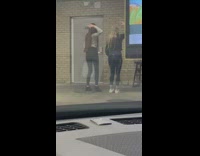 Two girls record tiktok dance in public with phone on electrical box