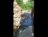 Blue shorts grandpa jumps off cliff water