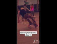Girl learns to roller skate at rink 