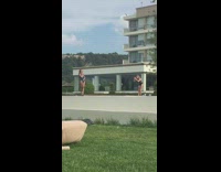 Woman takes picture in swimsuit at edge of pool
