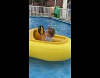 Little kid driving yellow bumper boat 