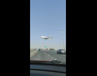 Plane landing fly over the highway road