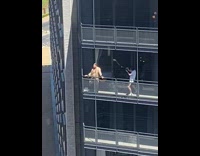 Man in gold robe poses at the balcony of the building