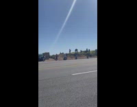 Biker does wheelie near water 