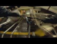 Guy rides bicycle down subway station stairs 