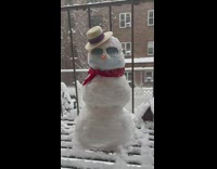 Snowman on fire escape wears face mask 