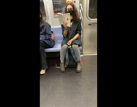 Man reads book on subways titled “trouble with testosterone” 
