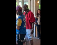 Man standing with snake wrapped on body