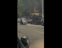 Guy holds dresser while on motorcycle 