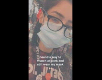 Girl cuts face mask in half eats