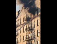 Firefighters putting out fire on burning apartment unit