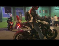 Man revs the engine with blue fire comes out the exhaust