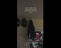 Wig hanging on wall with hats