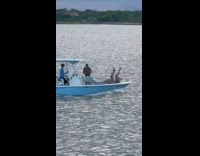 Two women lie down and raises feet on the boat