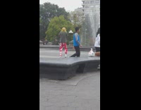 Guy moves erratically red pants water fountain 