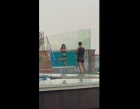 Black bikini girl poses pool glass wall 