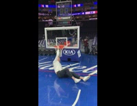 Guy hangs on very low basketball rim