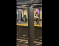 Guy carries white surfboard in subway 