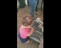 Baby girl help mother pick spoon from shelf