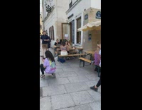 Man in green top raises feet and pose on the alley