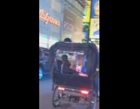 White shirt girl stands black rickshaw carriage 