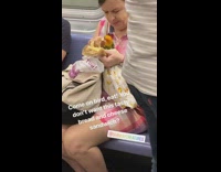 Woman feeds bird bread and cheese sandwich on the subway