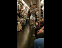 guy in grey head phones on train dancing