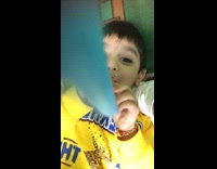 Kid boy blue party blower horn yellow sweater