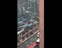 woman zooms in on sheet of snow falling into street
