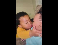 Kid kiss baby brother on the lips