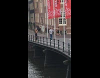 Black dress girl guy red banner bridge 