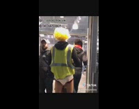 Guy in diaper yellow hair green vest walks into store during Black Friday and wishes every a happy holiday