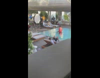 Guy orange suit swimming pool photo shoot