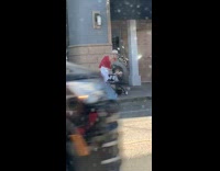 woman pictures phone on stroller