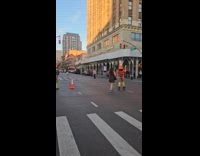 Traffic cone heads plays jump rope on intersection