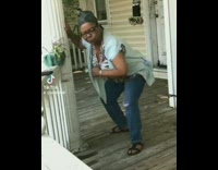 Middle aged woman dances with porch column 