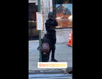 Guy in character helmet and costume stands on sidewalk 