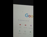 Tiny spider hangs on laptop computer