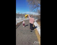 Parent walking with jacket in hand while toddler runs