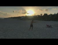 Men Play on Beach and Throw Bottled Water 