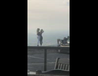 Two girls hug guy on black car