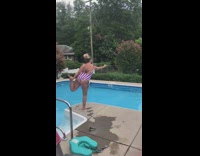 Girl struggles to lift leg up pool 