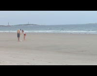 Woman white tube top poses in front of boyfriend