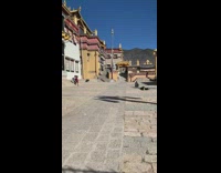 Woman sit ground gold pillars temple symbols