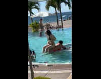 Woman bikini sit over another woman pool